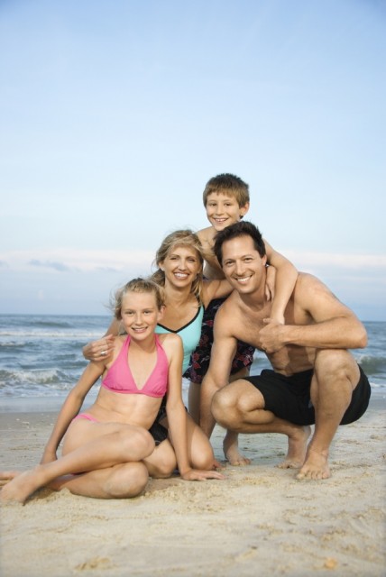 Smiling happy family on beach.